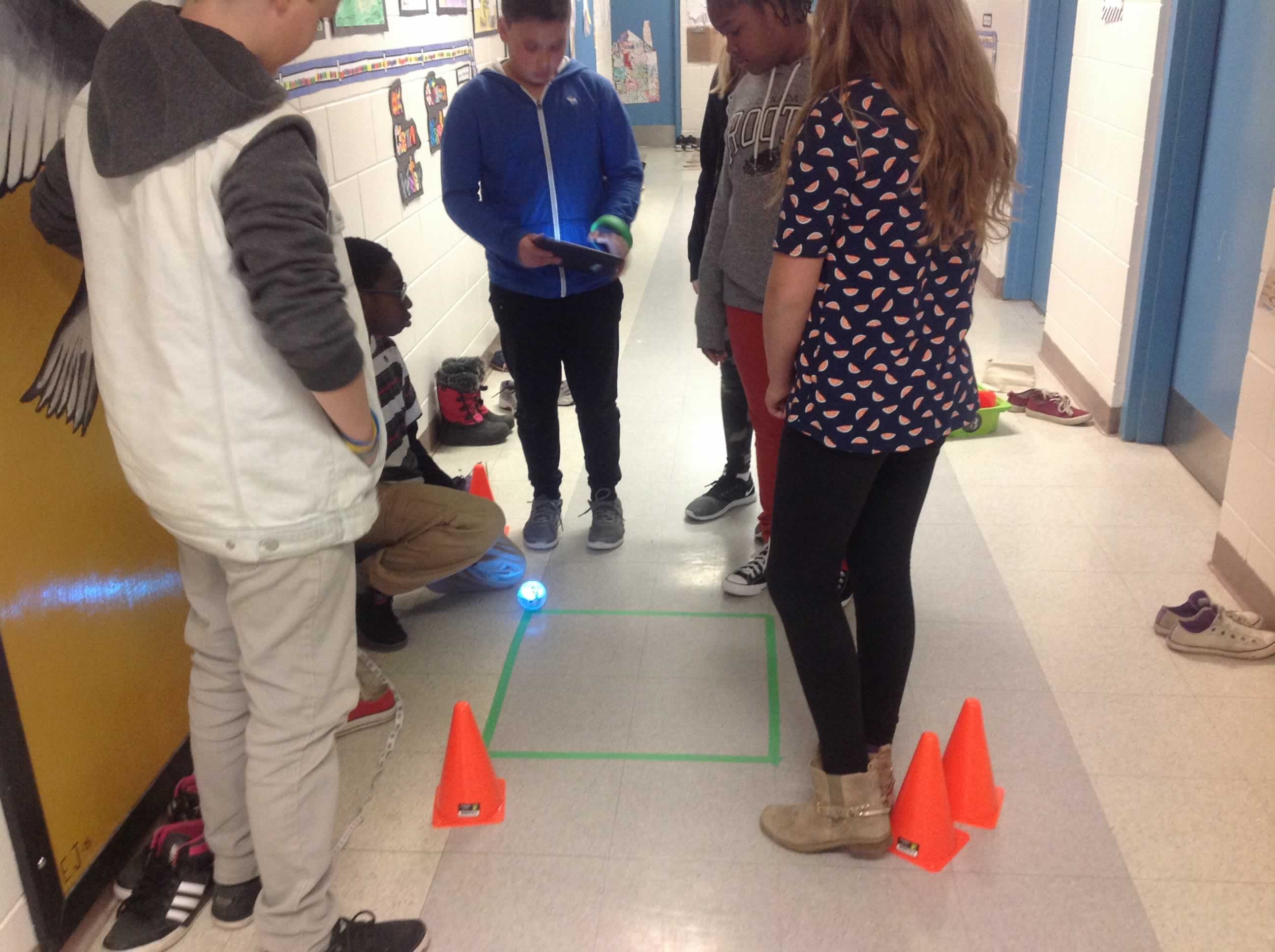 students in hall measuring angles using robot
